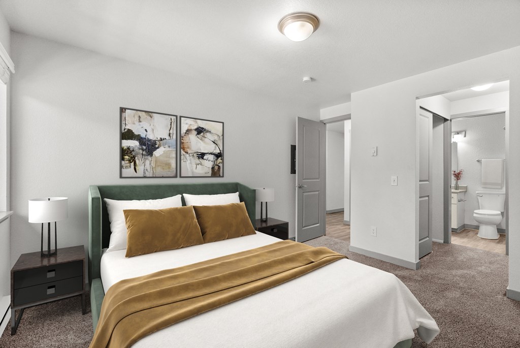 A bedroom with a bed, nightstand, and a painting on the wall.