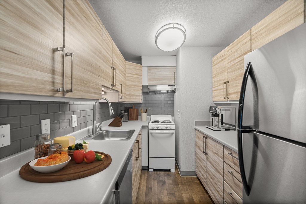 A modern kitchen with wooden cabinets and stainless steel appliances.