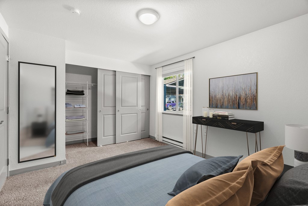 A bedroom with a large bed and a painting on the wall.