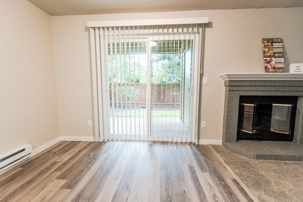 Puyallup Apartments - Cambridge on Seventh Apartments - Dining Room, Deck, and Fireplace at Cambridge on Seventh, Puyallup