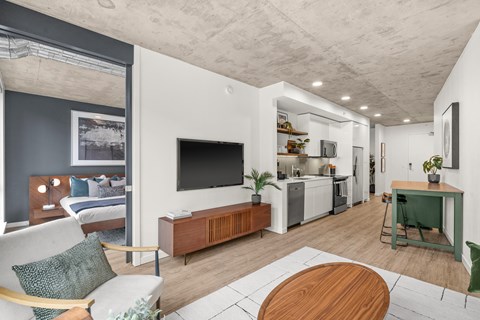 A modern living room with a white couch and a wooden coffee table.