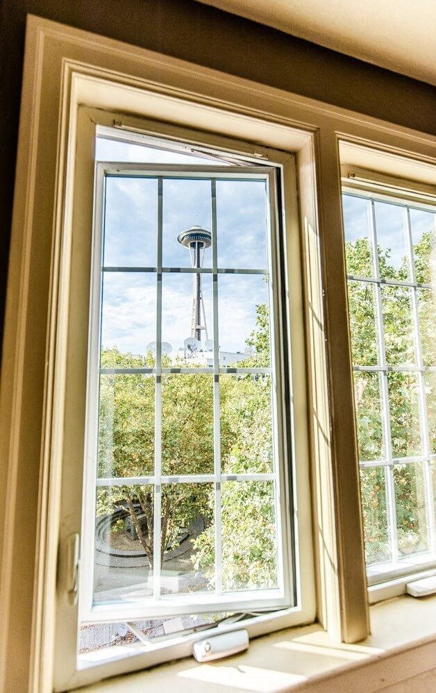 A window with a view of a balcony and trees. at Edwards on Fifth, Seattle, 98121