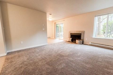 A room with a fireplace and a carpet on the floor. at Notch 8, Washington, 98444
