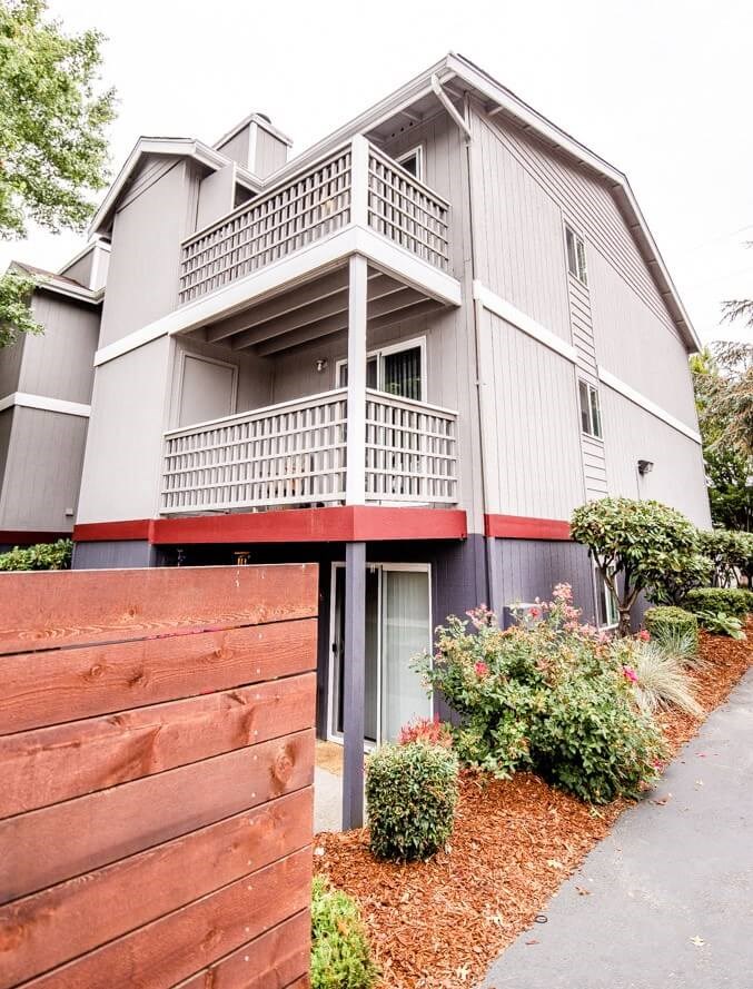 A grey building with a red fence in front. A grey building with a red fence in front. at Notch 8, Tacoma