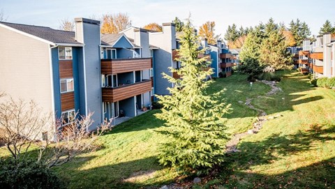 A view of apartment buildings with a green lawn in front. A view of apartment buildings with a green lawn in front. at Northpoint Apartments, Washington, 98407