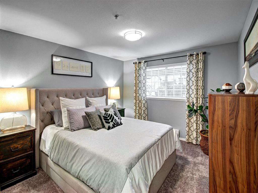 Bedroom with bed and lamp at Deer Creek Apartments, Puyallup, 98373