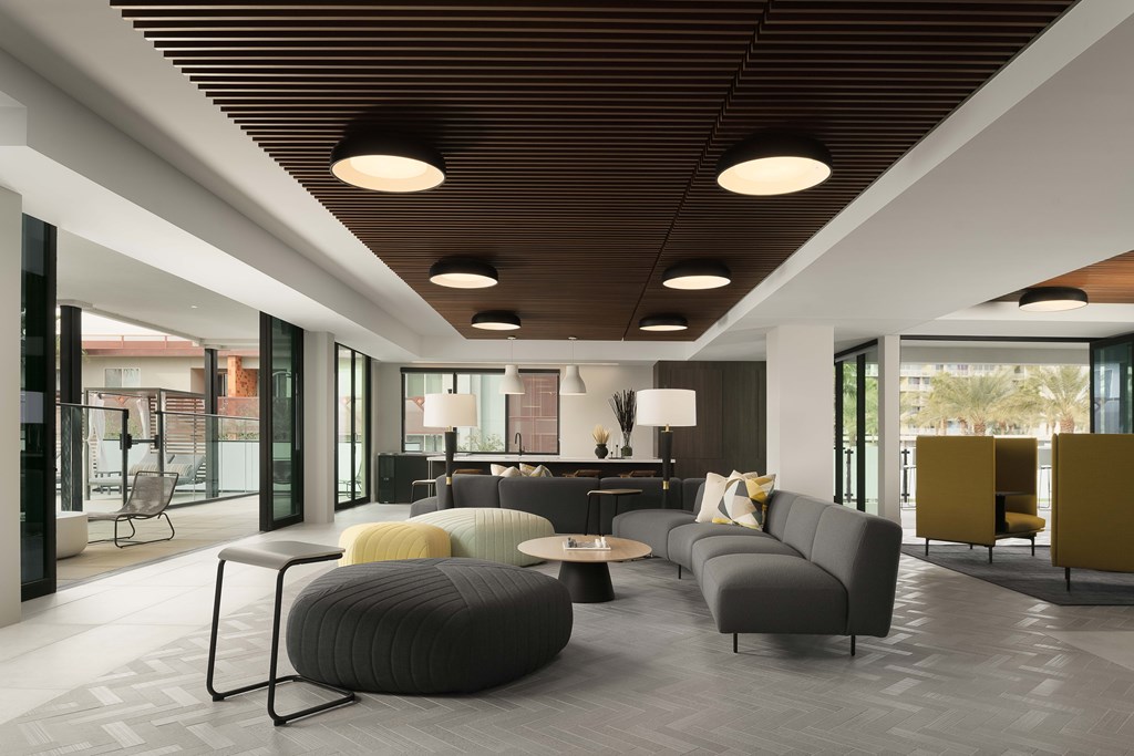 A modern living room with grey and yellow furniture.