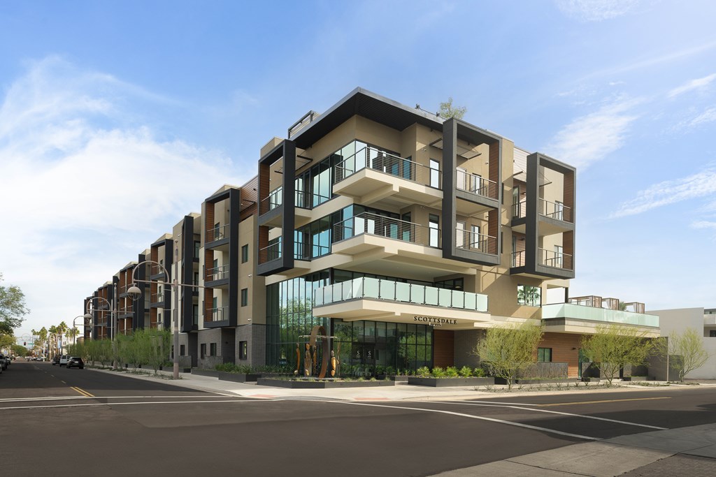 A modern apartment building with a clear blue sky above.