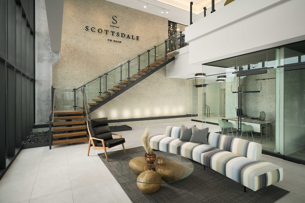 A modern living room with a staircase and a sofa.