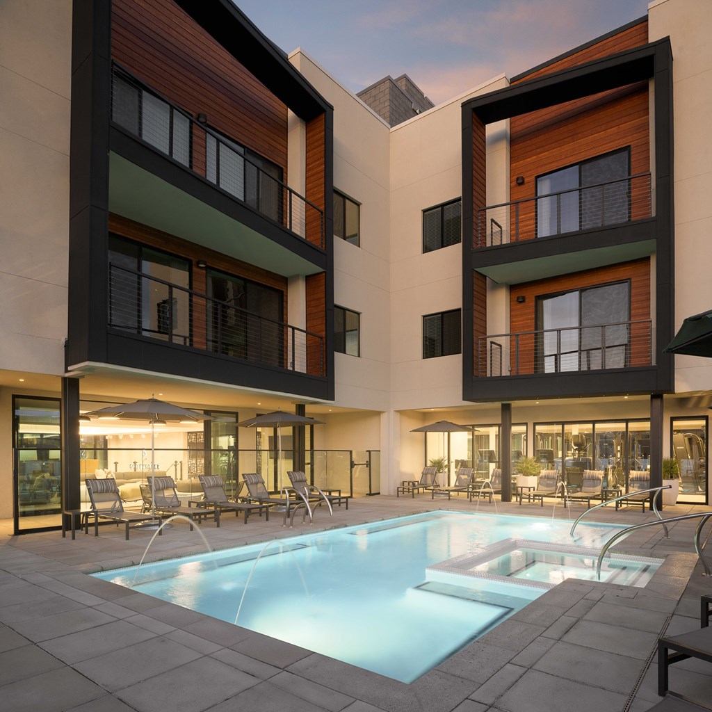 A modern building with a pool in front.