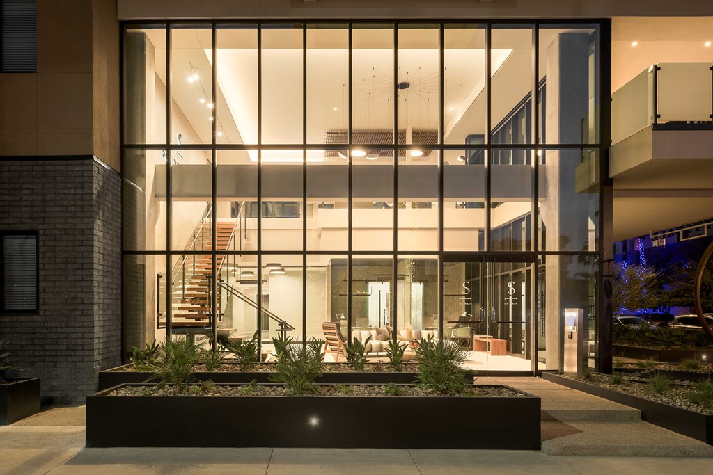 A modern house with a glass entrance and a staircase.