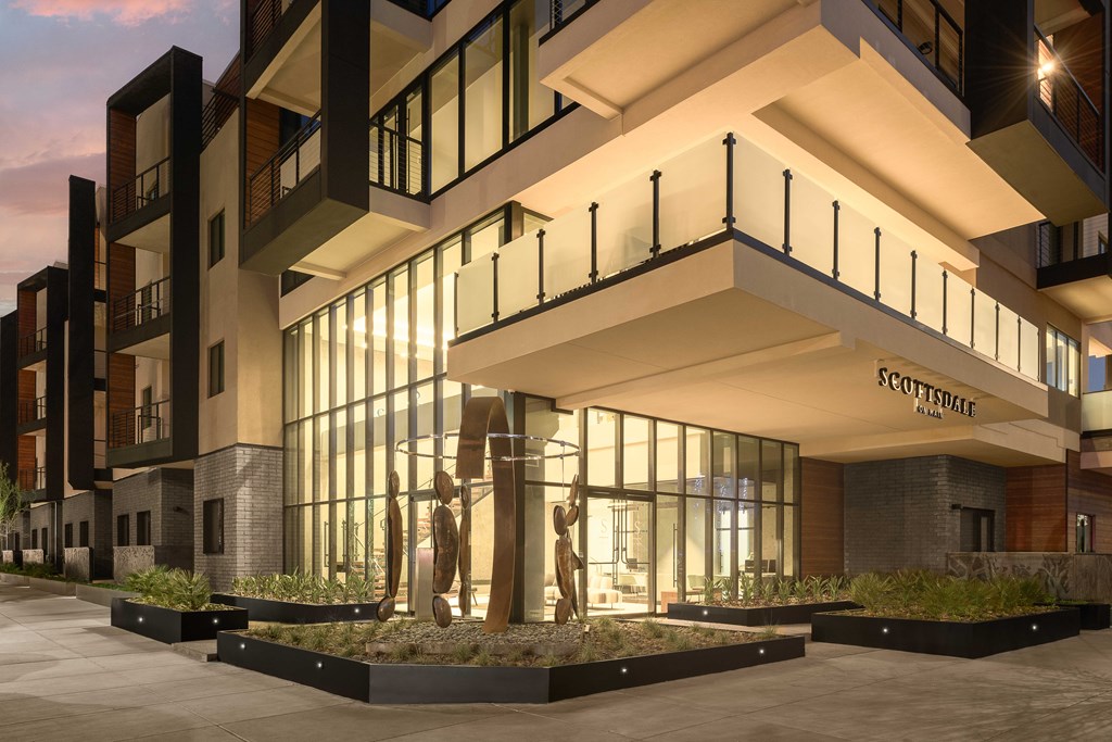 A modern building with a sculpture in front of it.