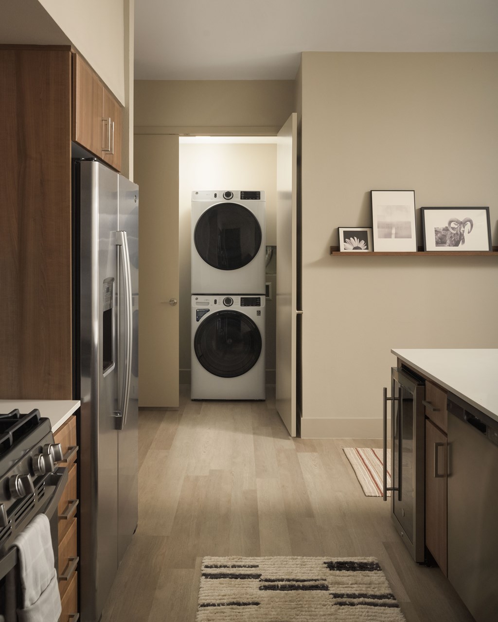 A modern kitchen with a washer and dryer built into the wall.