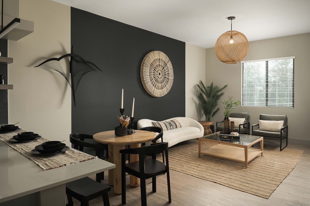 A modern living room with a dining table and chairs.