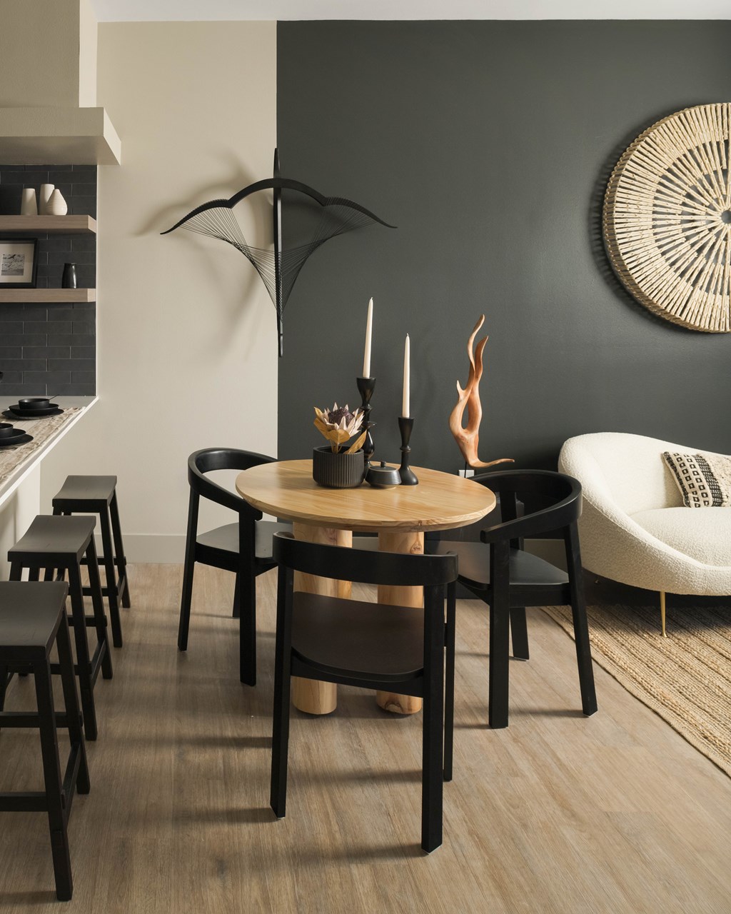 A modern dining room with a round table and chairs.