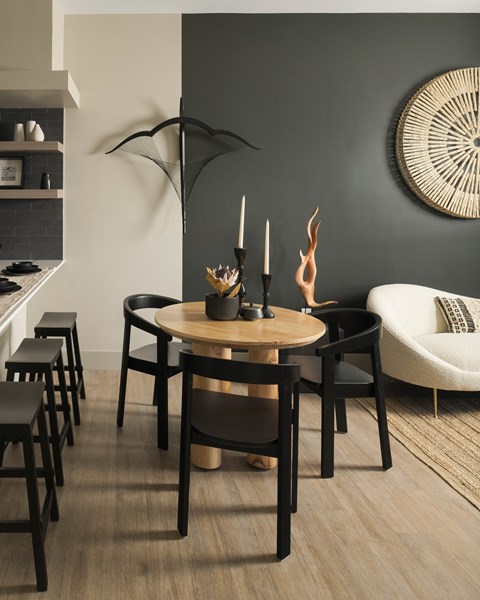 A modern dining room with a round table and chairs.