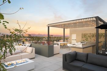 A modern outdoor living space with a fire pit and comfortable seating.