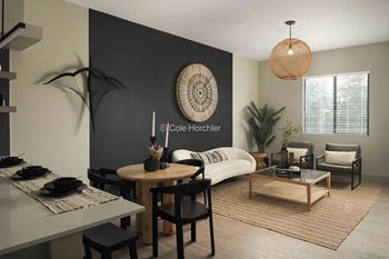 A modern living room with a dining table and a sofa.