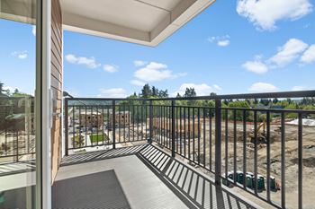 a balcony with a view of a construction site and a blue sky