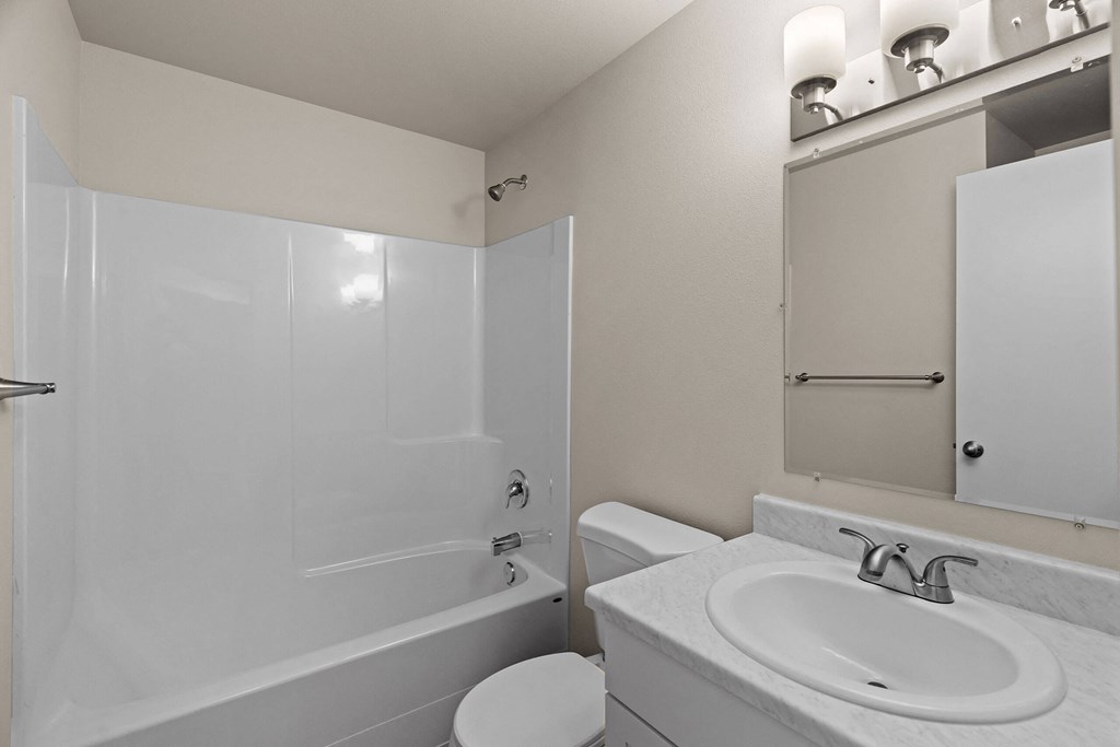 a bathroom with a sink and a toilet and a shower at Bellamy Park Apartments , Lakewood, Washington