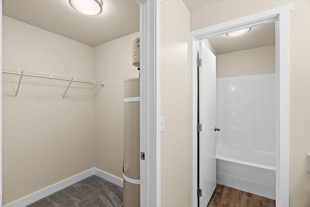 a renovated bathroom with a closet and a shower and a toilet at Bellamy Park Apartments , Lakewood, 98498