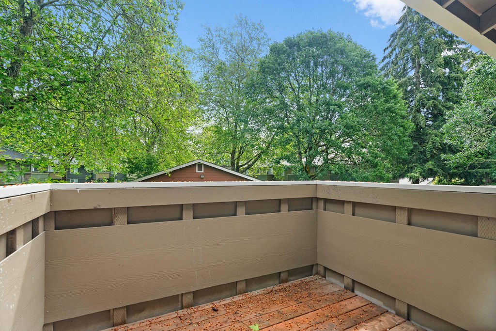 the view from the top of a balcony overlooking the trees at Bellamy Park Apartments , Lakewood, CA
