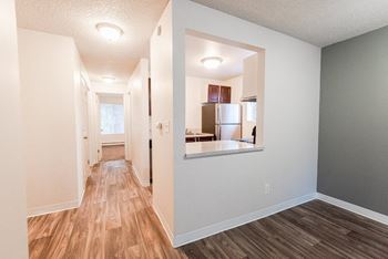 a renovated living room and kitchen with a hard wood floor at Bellamy Park Apartments , Washington