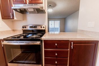 a kitchen with a stove top oven and a sink at Bellamy Park Apartments , Lakewood, 98498