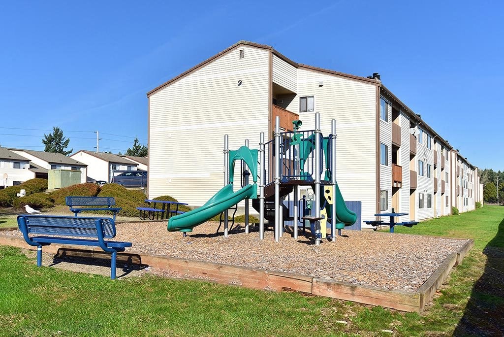 a playground in front of an apartment building
