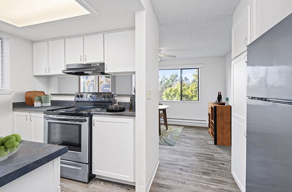 a kitchen with white cabinets and stainless steel appliances