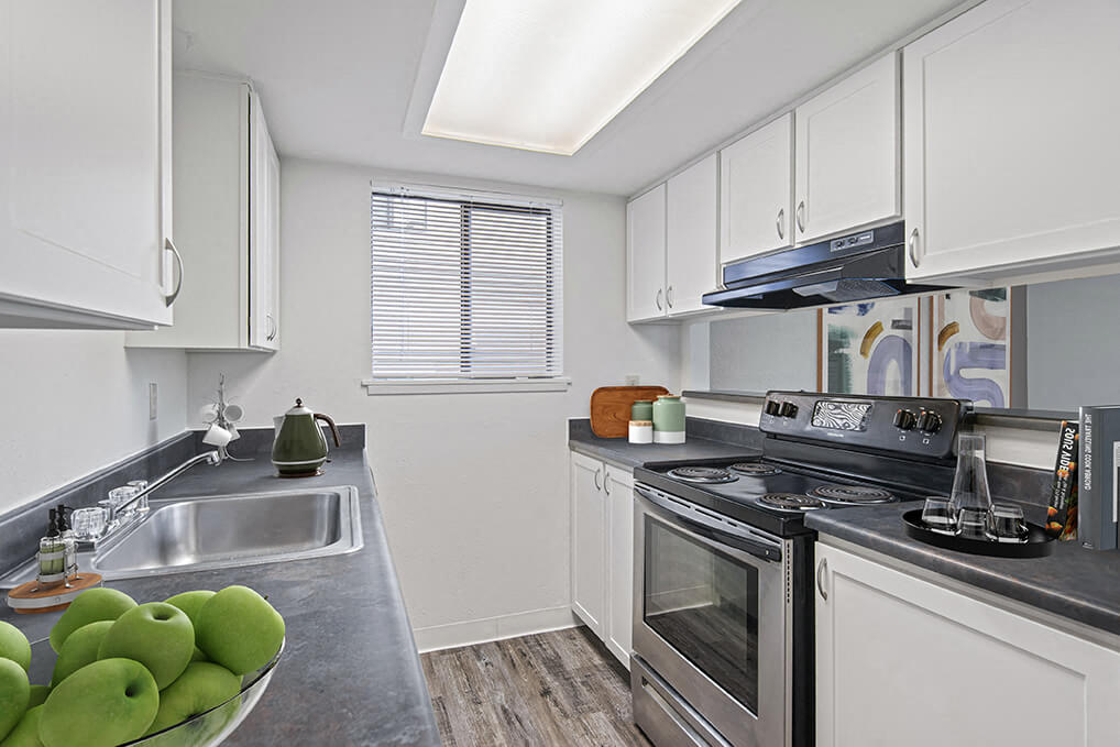 a kitchen with stainless steel appliances and white cabinets