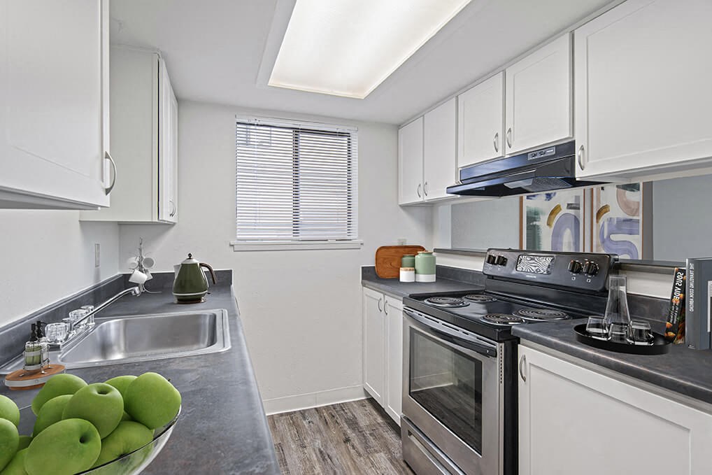 a kitchen with stainless steel appliances and white cabinets