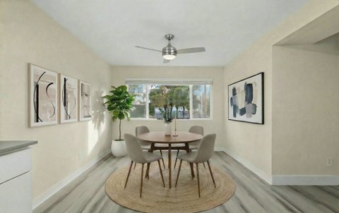 A dining room with a round table and chairs.