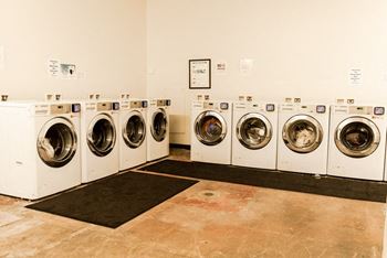 A row of washing machines in a laundromat at Addison on Fourth Apartments, Seattle
