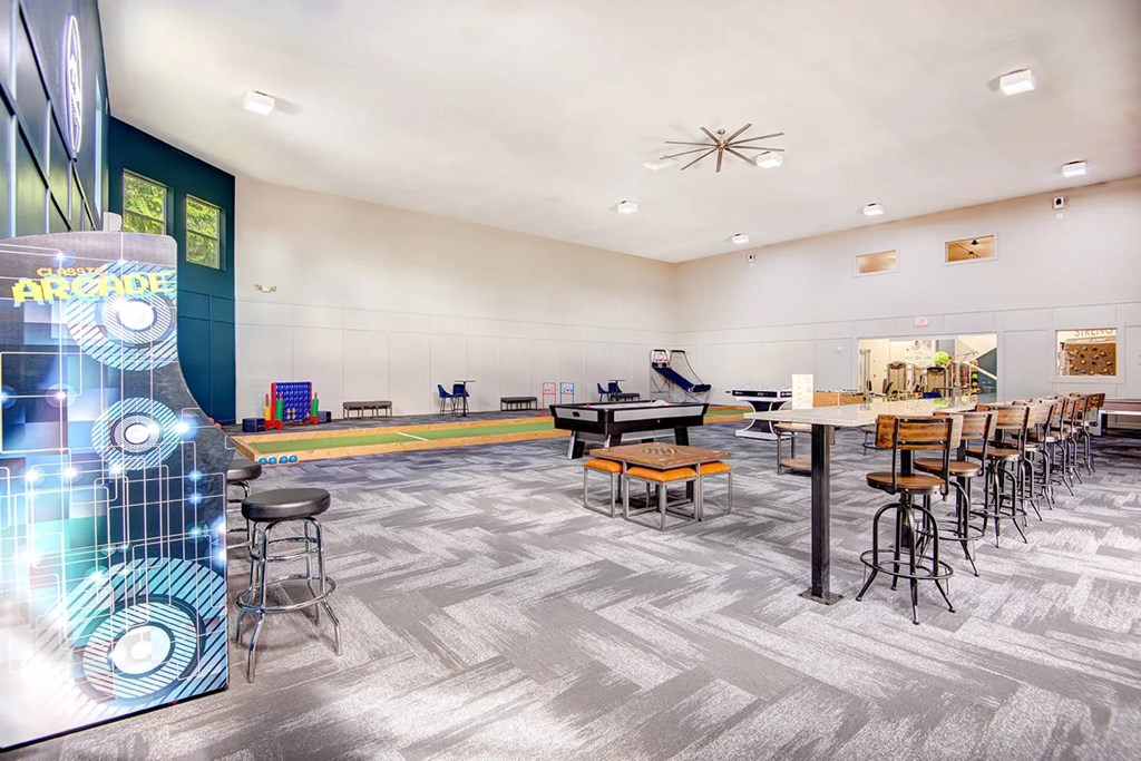 A room with a carpeted floor and a long table with chairs.