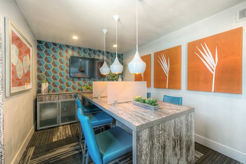 A dining area with a wooden table and blue chairs.