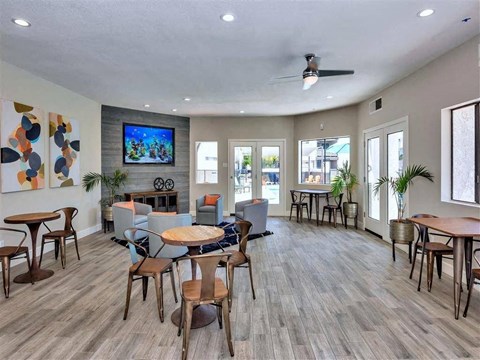 A spacious room with wooden floors and furniture.