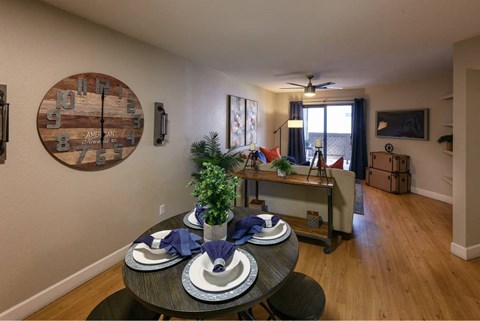 A dining room with a round table set for two.