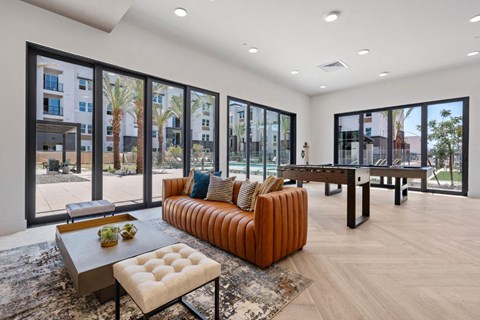 A modern living room with a brown leather sofa and a coffee table.