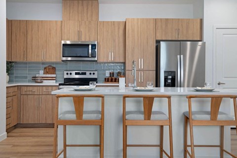 A kitchen with wooden cabinets and a white countertop.