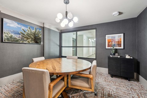 A modern dining room with a wooden table and chairs.