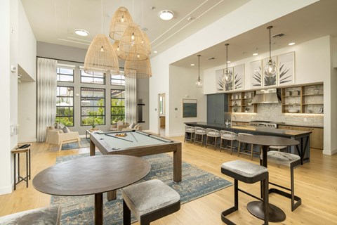A modern dining room with a large table and chairs.
