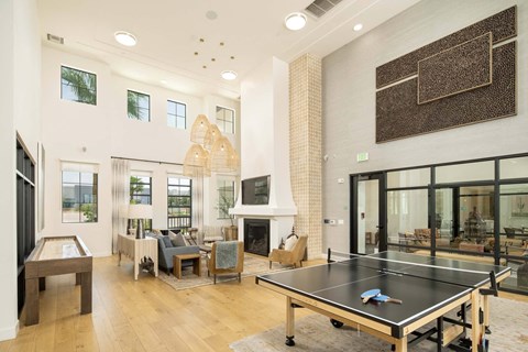 A ping pong table is in the middle of a living room.