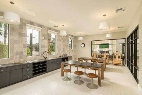 A modern kitchen with a dining table and chairs.
