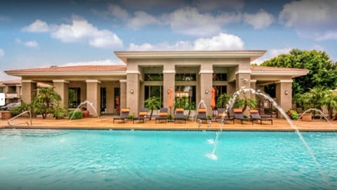 A large house with a pool in front.