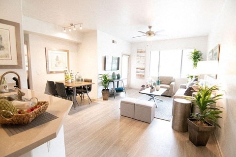 A living room with a dining table and chairs.