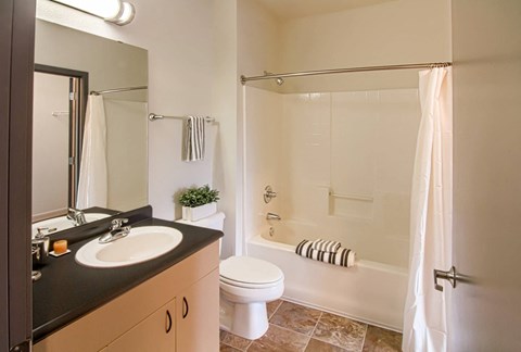 A bathroom with a sink, toilet, and bathtub.