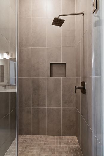 a shower with a glass door in a bathroom