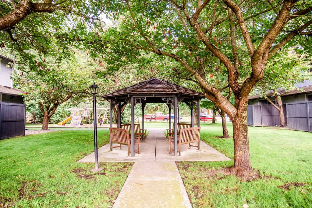 A gazebo is surrounded by trees and has a walkway leading to it. at The Retreat, Sumner, WA, 98390