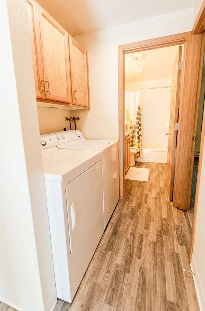A small kitchen with a white fridge and wooden cabinets. at The Retreat, Washington, 98390